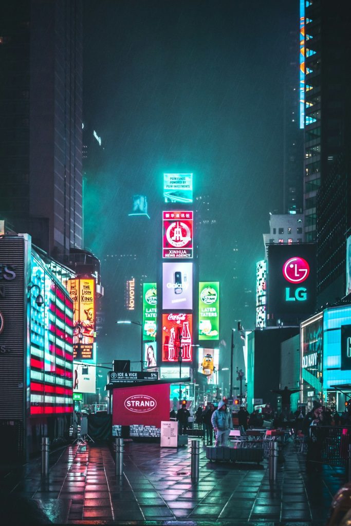 group-of-people-walking-near-high-rise-buildings-leikiomsxfs Neon Square.